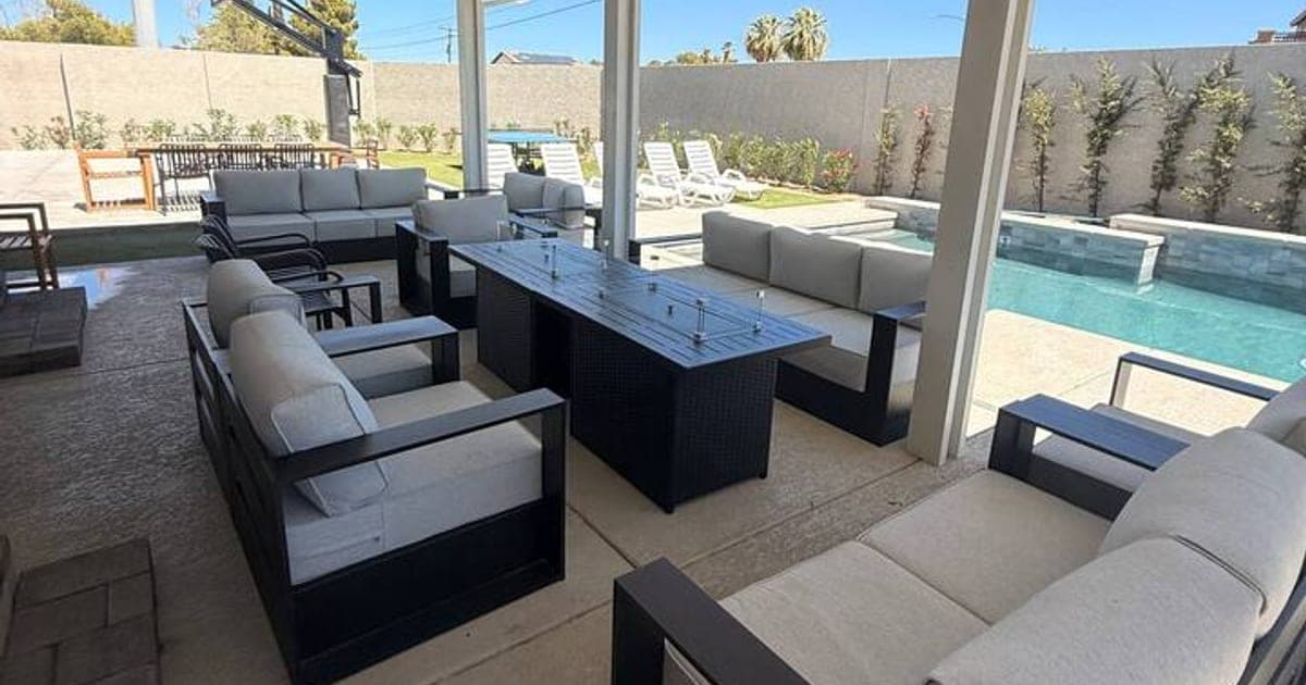 Covered outdoor lounge beside the pool at a vegasbnb Las Vegas luxury vacation home