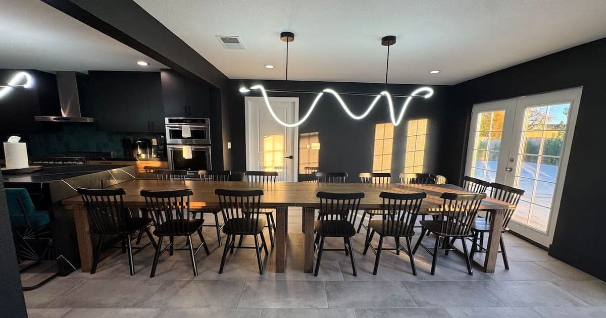 Long dining table with seating for a large group at a vegasbnb Las Vegas vacation home